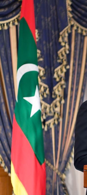 The national flag of the Maldives beside the lectern.